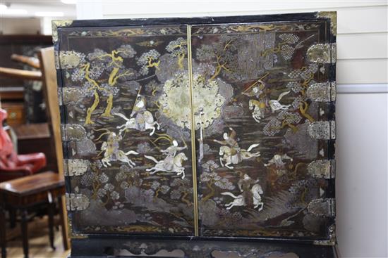 A late 17th century Chinese black lacquer cabinet, overall H. 5ft 3in.